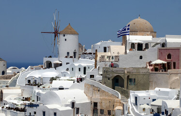 Fototapeta na wymiar Oia Town and windmill at beautiful Greek island Santorini in Greece. Oia is a small town and former community in the South Aegean on the Santorini.