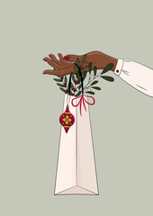 Kobieca ręka trzymająca torebkę podarunkową. Dziewczyna oferująca prezent. Bożonarodzeniowa ilustracja z pakunkiem prezentowym, bombką, jemiołą i innymi świątecznymi dekoracjami. Wektorowa ilustracja.