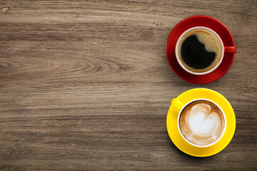 Black coffee and Latte Coffee or Cappuccino Coffee in red and yellow cup on wooden table, Flay lay wooden desk with coffee with copy space