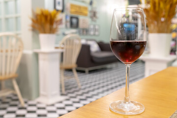 Red wine on wooden table in restaurant for dinner