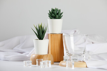 Gorgeous flower pot and empty drink glass on wooden tray with ice and cloth decoration on deluxe dining table for modern luxury spa and health care clinic