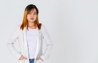 Portrait studio shot of Asian trendy fashionable urban beautiful happy dyed hair female model in casual long suit t shirt and denim jeans standing smiling look at camera posing on white background