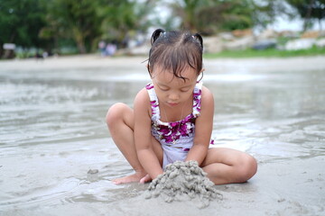 little child playing on the beach