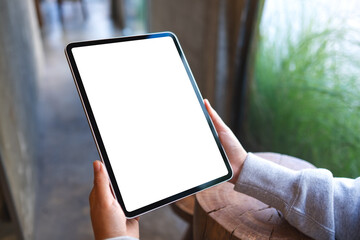 Mockup image of a woman holding digital tablet with blank white desktop screen