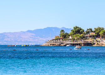 Blue sea, boats, mountains and islands on the Aegean coast. Summer vacation and coastal nature concept