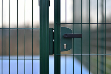 locked door to an outdoor soccer field in closeup