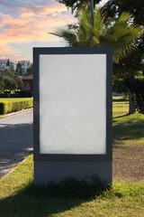 Blank billboard by the sea, on the grass and under cloudy sky. Ideal photo for holiday brochure. Selective Focus © Yasin