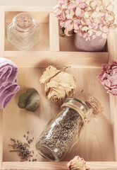 Dried flower, lavender herbs in bottles on a wooden background flay lay composition