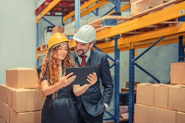 Supervisor holding digital tablet and taking with manager about stock of  inventory and products ready for shipment.