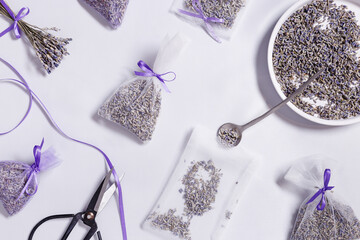 Making DIY lavender sachets for home, for gifts, natural scented bags from organza on white...