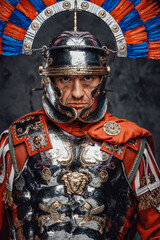 Studio shot of fearful roman soldier with colorful plumed helmet