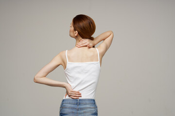 disgruntled woman pain symptoms in the joints arthritis light background