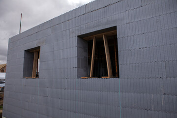 Construction of a passive house from durable and warm polystyrene blocks - obrazy, fototapety, plakaty