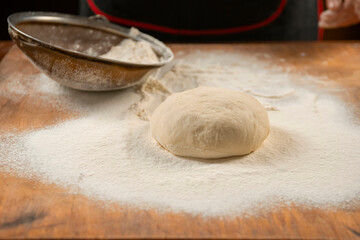 Baker kneading dough. Chef cook making dough for baking pie on wooden table. Process preparation homemade pastry. Cooking pasta, bread,spaghetti,khachapuri, food concept