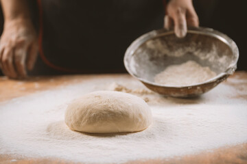 Baker kneading dough. Chef cook making dough for baking pie on wooden table. Process preparation homemade pastry. Cooking pasta, bread,spaghetti,khachapuri, food concept
