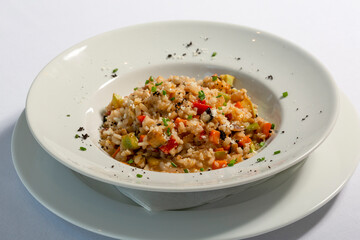 Risotto with vegetables served in white plate