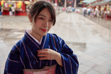 Fototapeta premium 浅草の浅草寺の前で微笑む着物姿の日本人女性