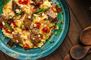 Portion of gourmet dish veal cheeks with orzo pasta