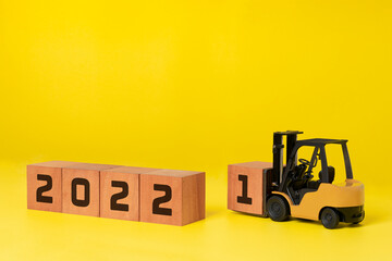 2022 new year concept. happy new year background industrial concept, forklift carrying box to...