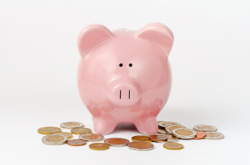 Piggy bank and euro coins on white background. Money savings concept.
