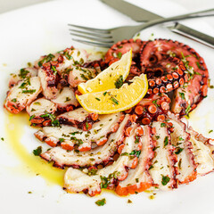 Octopus carpaccio on white background. Mediterranean food, Organic Healthy eating.