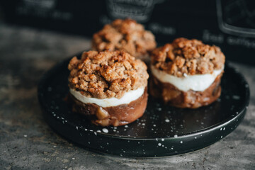 Apple crumble dessert on black plate