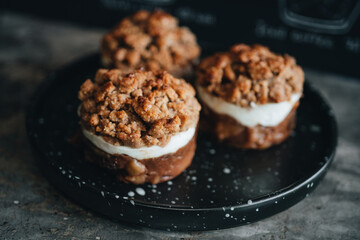 Apple crumble dessert on black plate