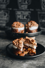 Apple crumble dessert on black plate