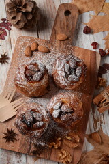 Baked apples with nuts and raisins. Homemade baked apples in the oven, with sugar powder close-up. Holiday dessert
