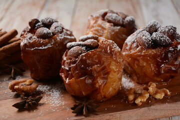 Baked apples with nuts and raisins. Homemade baked apples in the oven, with sugar powder close-up. Holiday dessert