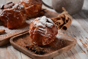 Baked apples with nuts and raisins. Homemade baked apples in the oven, with sugar powder close-up. Holiday dessert