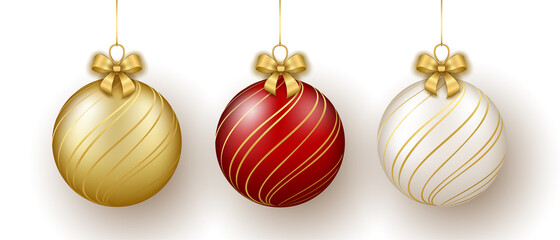 Christmas and New Year decor. Set of gold, white and red glass ornament balls on ribbon with bow.