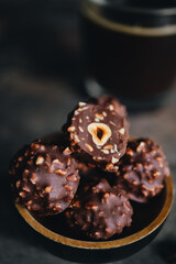 Handmade chocolate ferrero rocher in plate at dark background