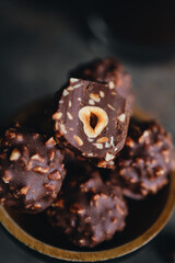 Handmade chocolate ferrero rocher in plate at dark background