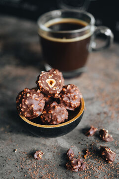 Handmade chocolate ferrero rocher in plate at dark background