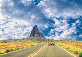 Obraz premium Old yellow truck on the highway in Arizona, USA