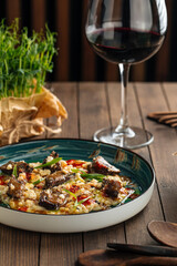 Portion of gourmet dish veal cheeks with orzo pasta