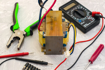 electric transformer pliers and ampervoltmeter on the table surface