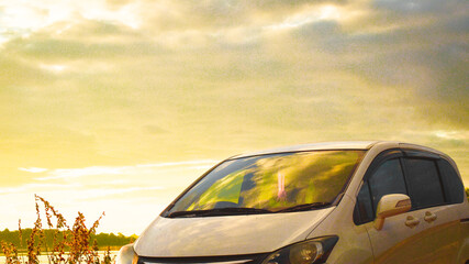 white car golden yellow sky scenery background