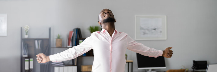 Man Doing Stretch Exercise At Work