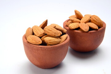 Fresh almonds in the wooden bowl, Organic almonds, almonds border white background, Almond nuts on a dark wooden background. Healthy snacks. Top view. Free space for text.
