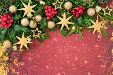 Christmas background border abstract composition with holly, cedar, ivy and gold glitter tree...