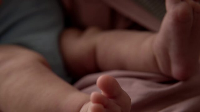 Baby Feet On Mother Hands. Cute Tiny Newborn Kid's Legs On Female Embrace Closeup. Mom And Her Child. Happy Family Concept. Beautiful Conceptual Video Of Maternity. Adorable Tiny Toes Selective Focus.