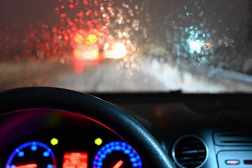 Dangerous winter season with snow on the road. The interior of the car from the driver's point of...