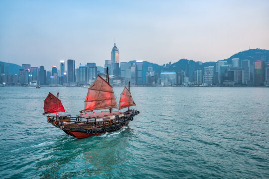 Junk boat with red sail at the Victoria Harbour in Hongkong, China