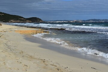 Fototapeta na wymiar A beach with yellow sand and the sea in the Natural Park Las Salinas, Ibiza