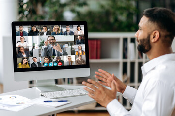 Online video meeting, distant communication. Indian businessman, holds negotiation with multiracial...