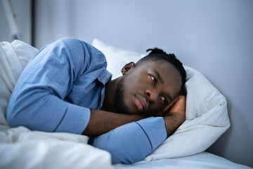 Young Man Suffering From Insomnia Lying