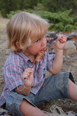 little child eating outdoor