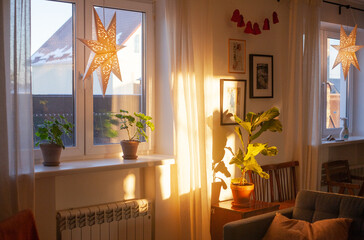 Bright Nordic-style living room, Christmas star in the window. Christmas time, advent, interior decor © Евгения Ивченко
